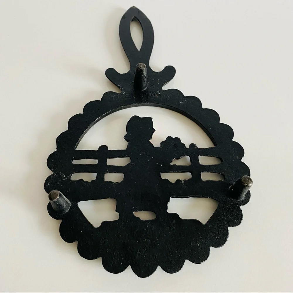 Vintage  Cast Iron Amish Woman and  man Trivets.